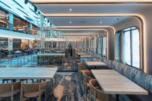 "Image of ambient seating, mirrored wall, and beautiful lighting at Dr. Inks Ph.D. bar on Carnival Jubilee.